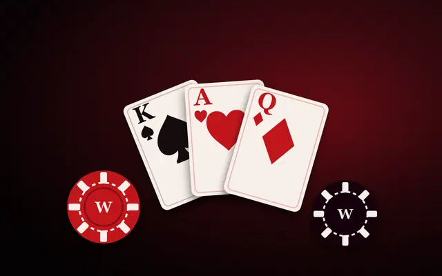 Playing cards and casino chips on a dark red background